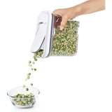 Clear medium dispenser with easy-open lid and pour spout, ideal for organizing dry foods like granola and nuts.