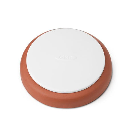 A food-safe terracotta disk designed to keep brown sugar soft in OXO POP containers, preventing clumping and moisture loss.