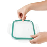 Clear rectangular glass food storage container with secure locking tabs and ergonomic design for versatile meal prep and organization.