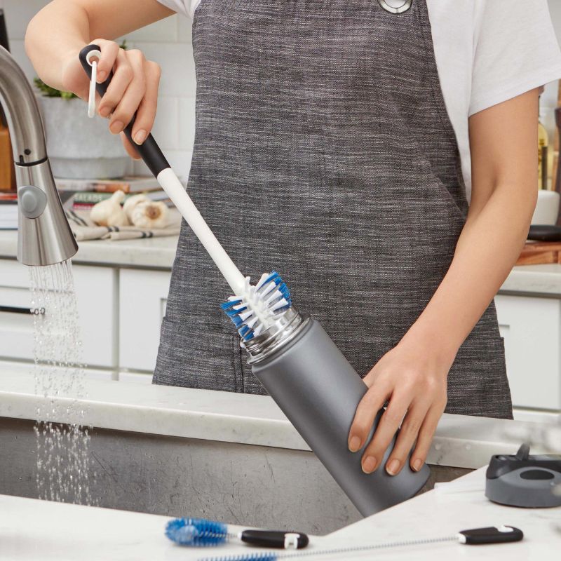 OXO Water Bottle Cleaning Set featuring a long bottle brush, straw brush, and detail cleaner for hygiene and easy storage.