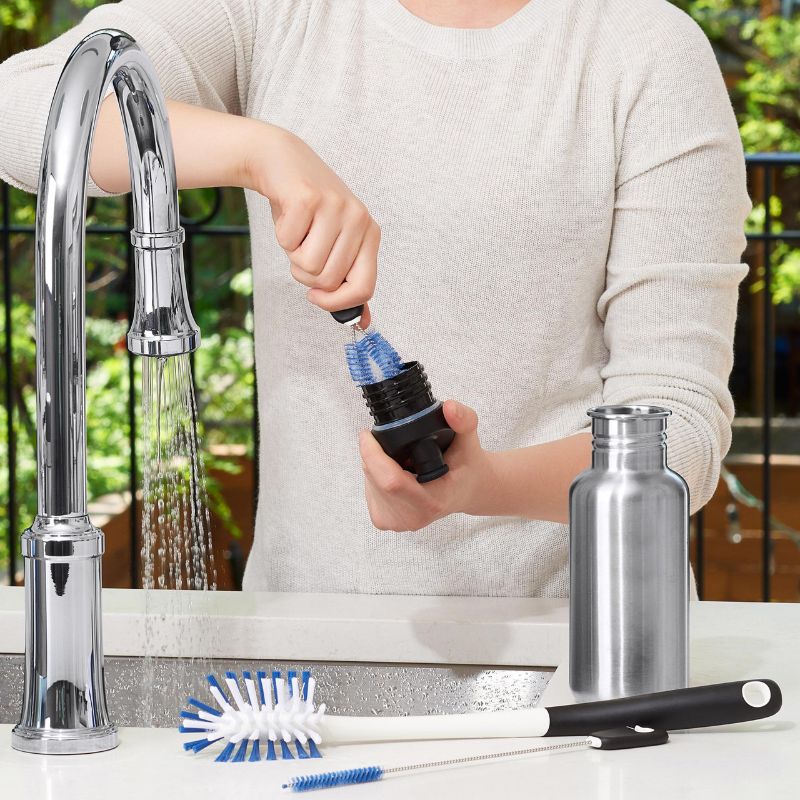 OXO Water Bottle Cleaning Set featuring a long bottle brush, straw brush, and detail cleaner, all with durable nylon bristles.