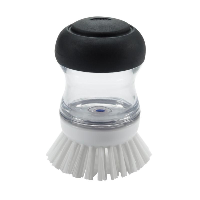 Ergonomic soap dispensing palm brush with durable bristles for easy cleaning of non-stick cookware and pots.