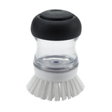 Ergonomic soap dispensing palm brush with durable bristles for easy cleaning of non-stick cookware and pots.