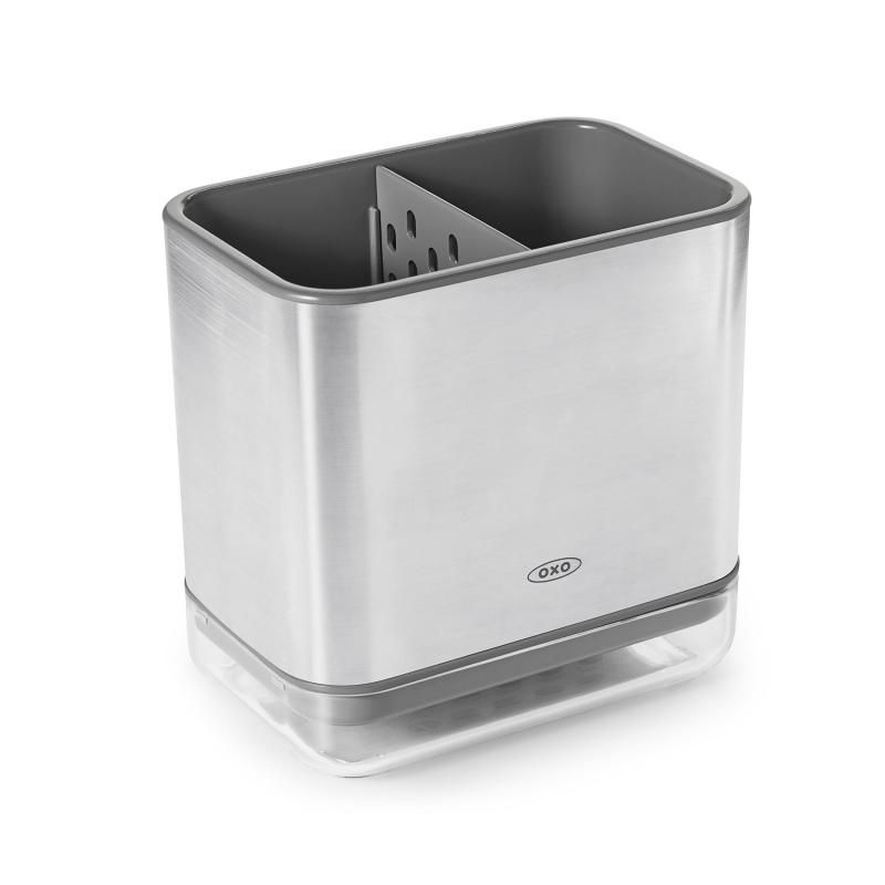 Sleek stainless steel sink caddy with a divider for organized sponges and brushes, featuring a ventilated drip tray.