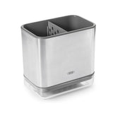 Sleek stainless steel sink caddy with a divider for organized sponges and brushes, featuring a ventilated drip tray.