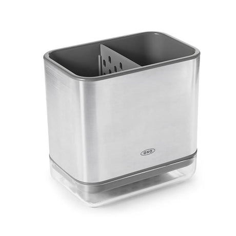 Sleek stainless steel sink caddy with a divider for organized sponges and brushes, featuring a ventilated drip tray.