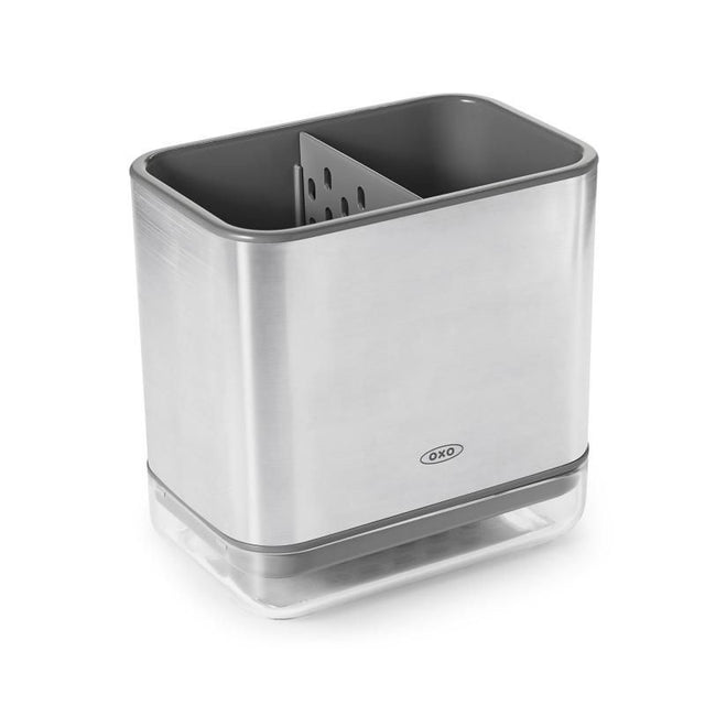 Sleek stainless steel sink caddy with a divider for organized sponges and brushes, featuring a ventilated drip tray.