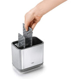 Sleek stainless steel sink caddy with divider for organized cleaning tools, featuring ventilation and drip tray for efficient drying.