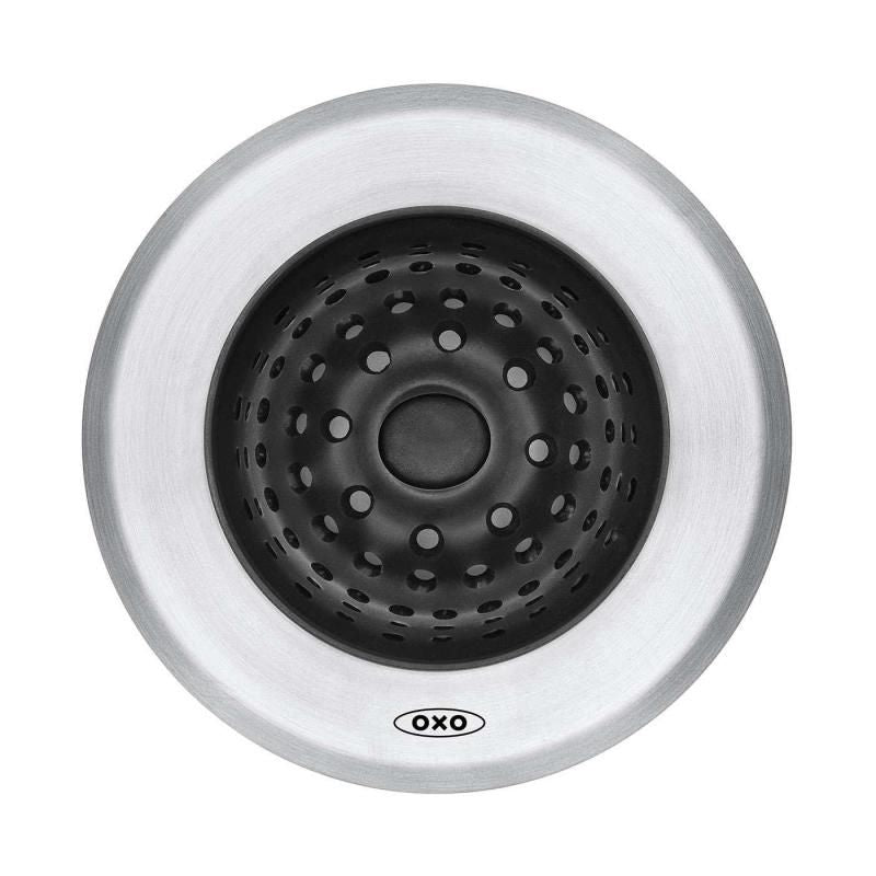 Sleek OXO Good Grips Silicone Sink Strainer traps food scraps, flips inside out for easy disposal, and protects your sink.