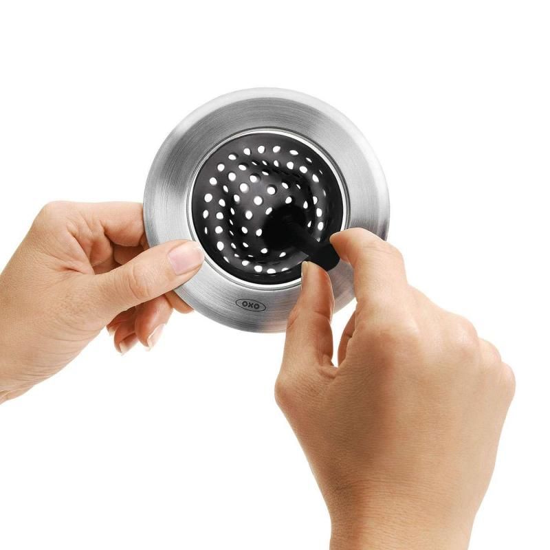 Sleek stainless steel and flexible silicone sink strainer traps food scraps and prevents clogs, easy to clean and eco-friendly.
