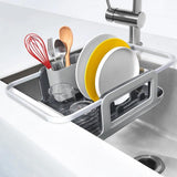 Sleek aluminum dish rack with extendable arms, plate holders, and utensil cup for efficient drying over the sink.