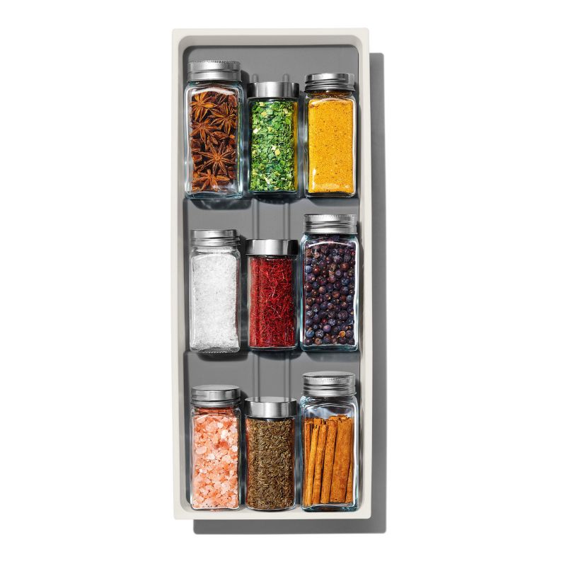 Tiered spice drawer organiser from OXO, designed for easy visibility and access to round and square spice jars.