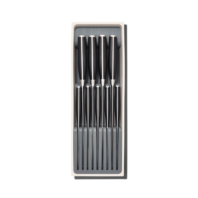 Compact knife drawer organizer from OXO with slots for 5 small and 4 large knives, featuring non-slip feet and a removable tray.