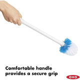 Compact toilet brush and canister with hygienic automatic door, ergonomic handle, and tapered bristles for deep cleaning.