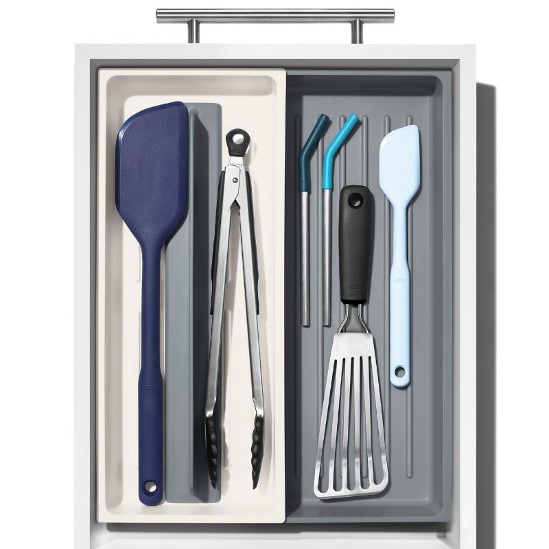 Expandable tool organiser for kitchen utensils, featuring adjustable dividers, non-slip feet, and square corners for a neat fit.