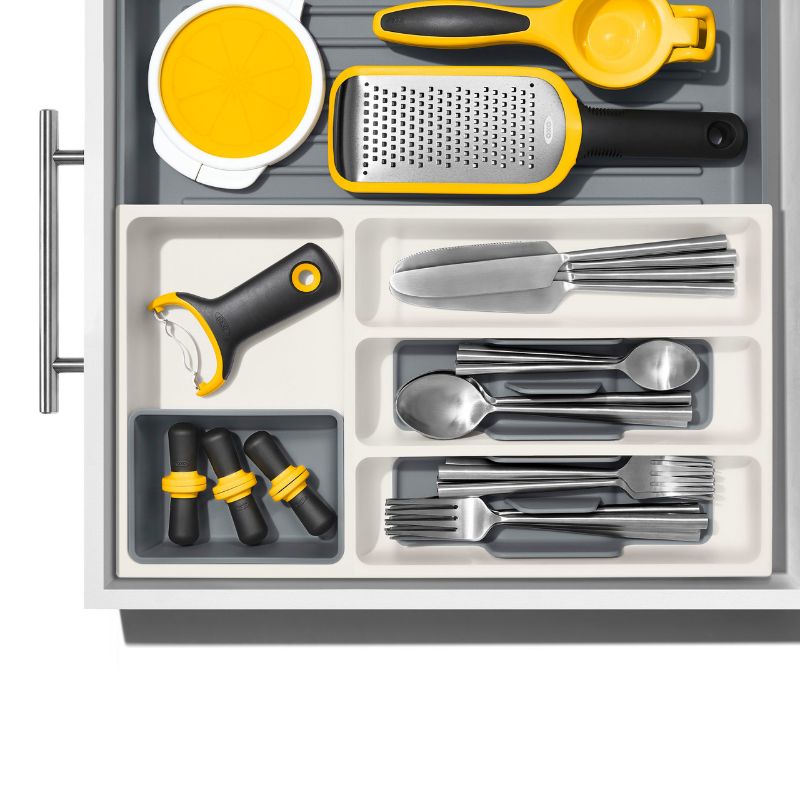 Expandable drawer organiser with versatile compartments for utensils, tools, and gadgets, ensuring neat and easy access.