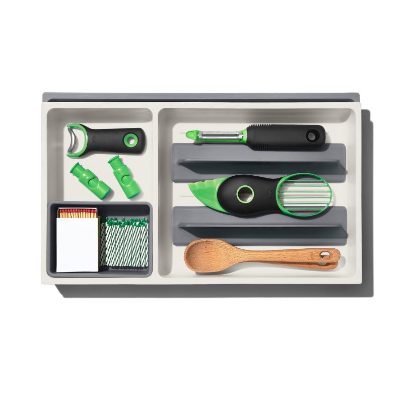 Large expandable kitchen drawer organizer with adjustable dividers and storage cup for utensils and gadgets.