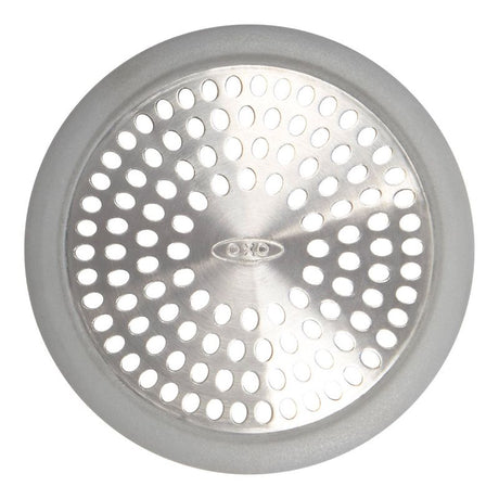 Stainless steel OXO Bathtub Drain Protector with silicone rim, designed to catch hair and debris while allowing water to flow.