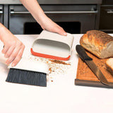 Compact dustpan and brush set with storage-friendly design, rubber lip for efficient cleaning, and angled handle for easy use.