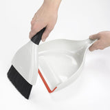 OXO Good Grips Dustpan & Brush Set featuring a whisk-broom design, ergonomic grip, and flexible lip for efficient cleaning.