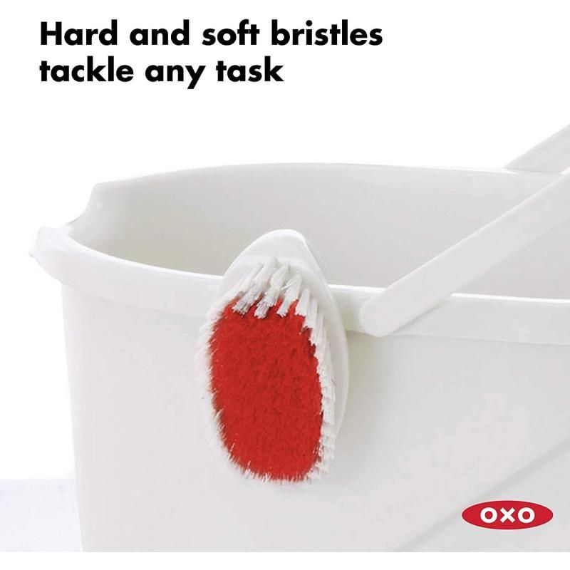 Ergonomic scrub brush with stiff and gentle bristles for efficient cleaning of grout, carpets, and surfaces, featuring a non-slip handle.