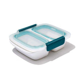 Clear BPA-free divided container with two compartments, leakproof design, and stay-cool handles for easy meal transport.