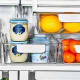 Clear storage bin with rounded handles, ideal for organizing fridge items like yoghurt cups and berries, measuring 15x38x8 cm.