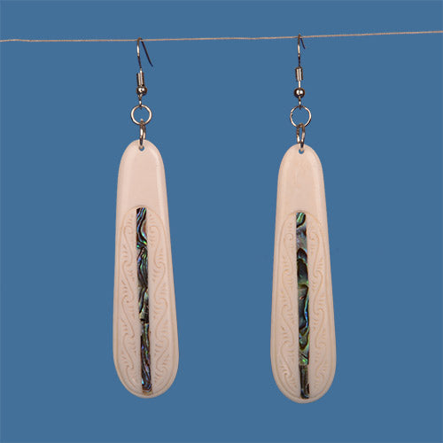 Handcrafted Bone Earrings featuring vibrant Paua shell inlay, reflecting authentic Maori artistry and culture.