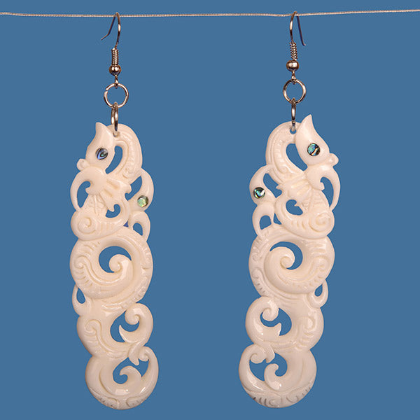 Double Manaia Bone Earrings featuring Koru design, handcrafted with paua shell accents, symbolizing protection and new beginnings.