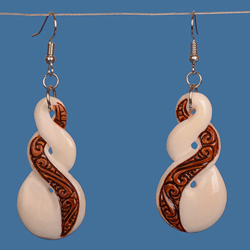 Handcrafted bone earrings with a unique double twist design, showcasing Maori craftsmanship and ethical beef-bone material.