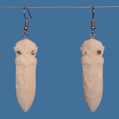 Bone Tiki Earrings with paua shell accents, handcrafted from beef-bone, showcasing Maori culture and ancestral connections.