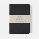 Elegant black A5 lined notebook with soft vegan leather cover and cream pages, perfect for writing, journaling, and sketching.