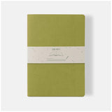 Ciak Mate A4 lined notebook in vibrant Lime, featuring 64 cream pages and a soft vegan leather cover for easy, stylish writing.