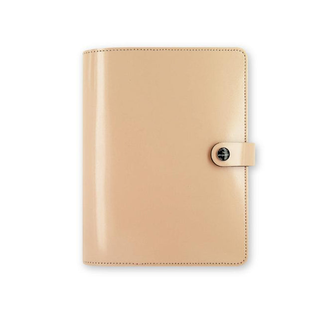 Elegant A5 nude leather Filofax organiser with secure strap, diary, pockets, and pen loops for efficient planning.