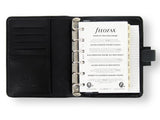 Compact red Filofax Metropol Pocket organiser with faux leather, featuring rings, pockets, and a weekly planner layout.