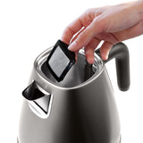 De'Longhi Distinta Titanium Kettle in matte metallic finish, 1.7L capacity with cordless design and safety features.