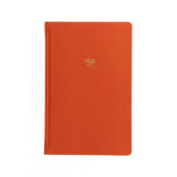 Vibrant orange A5 lined notebook with textured cover, gold foil motif, gilt edges, and ribbon marker for stylish note-taking.