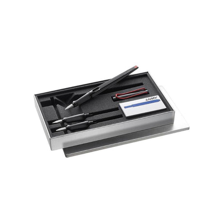 Lamy Joy Fountain Pen Calligraphy Set in metal box, includes ergonomic pen, interchangeable nibs, and blue ink cartridges.