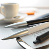 Lamy Noto Ballpoint Pen in Black/Silver, featuring a triangular design for comfort, matte finish, and smooth writing experience.