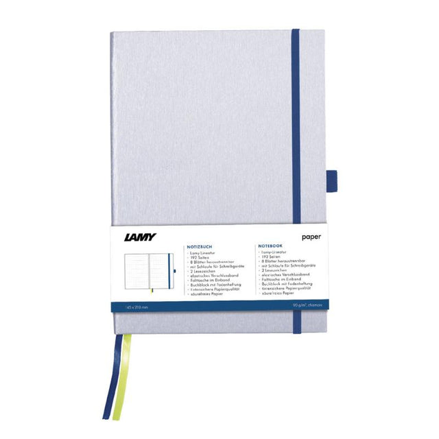 Elegant silver Lamy A6 notebook with ocean blue edges, featuring 192 pages of bleedproof paper and pen loop for easy writing.