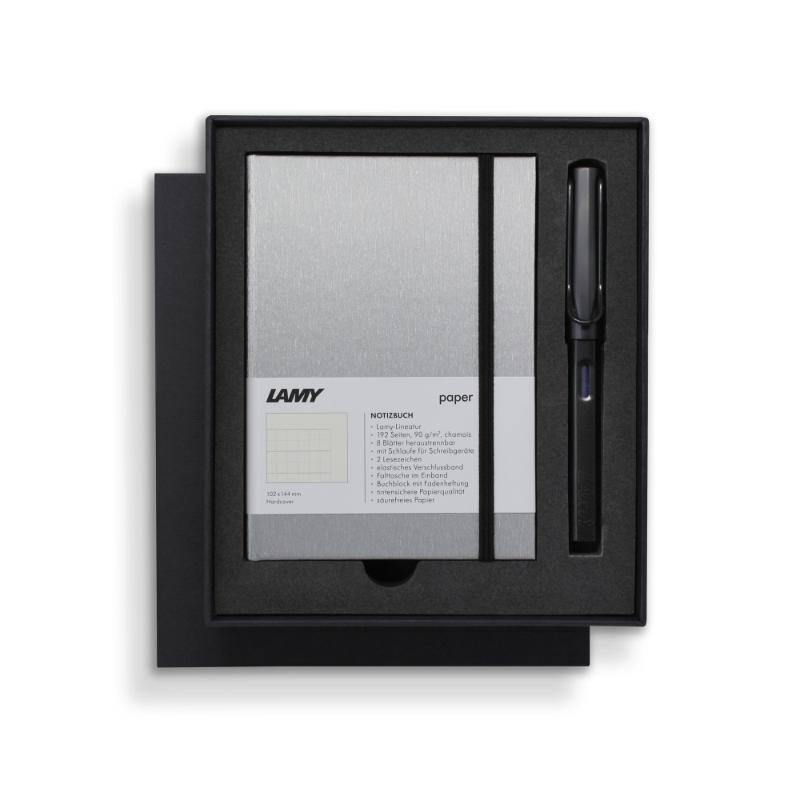 Lamy Notebook Fountain Pen Gift Set featuring a black anodized pen and stylish A6 notebook with gilt pages and pen loop.