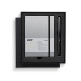 Lamy Notebook Fountain Pen Gift Set featuring a black anodized pen and stylish A6 notebook with gilt pages and pen loop.