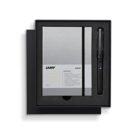 Lamy Notebook Fountain Pen Gift Set featuring a black anodized pen and stylish A6 notebook with gilt pages and pen loop.