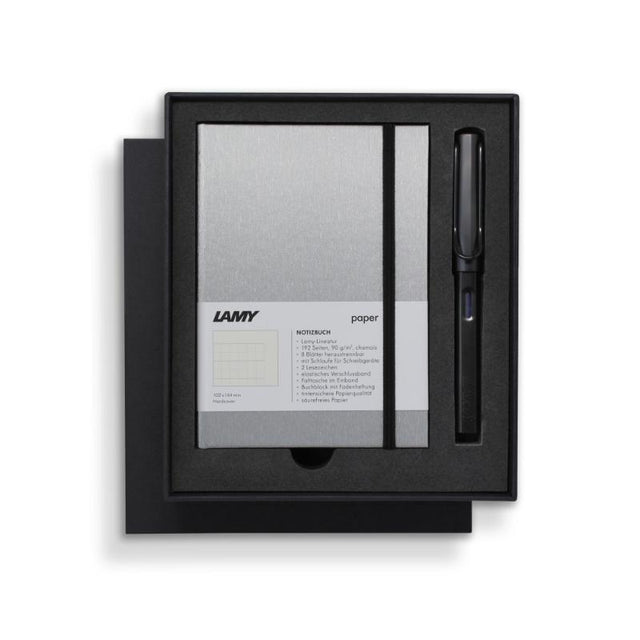 Lamy Notebook Fountain Pen Gift Set featuring a black anodized pen and stylish A6 notebook with gilt pages and pen loop.