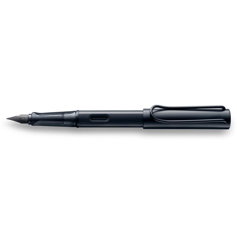 Lamy Notebook Fountain Pen Gift Set featuring a black anodized pen, A6 hardcover notebook with gilt pages, and accessories.