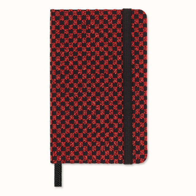 Moleskine LE Shine Notebook in metallic red with a hard cover, elastic closure, and ivory acid-free paper, elegantly packaged.