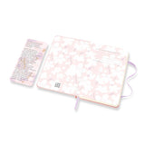 Moleskine Sakura notebook features cherry blossom designs, ruled pages, elastic closure, and expandable pocket for inspiration on the go.