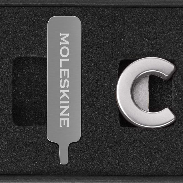 Silver Moleskine Pins C, stylish zinc alloy letter pins for personalizing notebooks, attaching effortlessly to elastic closures.