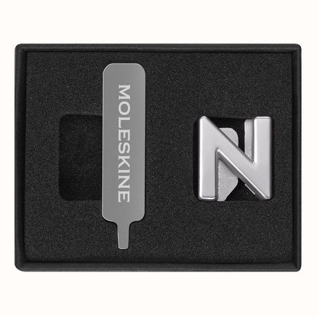 Stylish silver Moleskine Pins for personalizing notebooks with initials or words, crafted from durable zinc alloy.