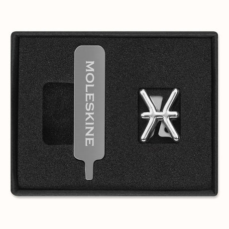 Silver Moleskine pin featuring the Pisces zodiac symbol, adding elegance and personalization to your stationery items.